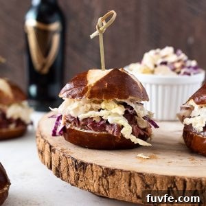 Crispy Corned Beef Sliders with Pickle Slaw 7 Guinness corned beef sliders with wooden pick through top.