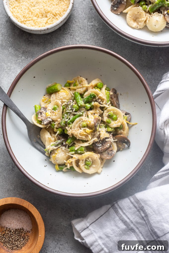One-Pot Spring Pasta Primavera Recipe with Fresh Veggies 10 One Pot spring pasta primavera in a bowl with parmesan cheese on top.
