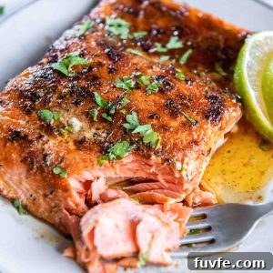 Blackened Salmon with Cajun Spice and Lemon Butter 9 Blackened salmon on a plate with a fork flaking a corner