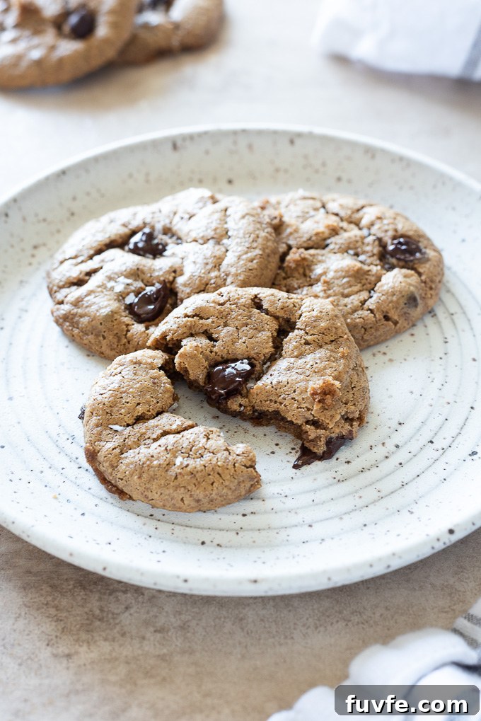 Almond butter cookie pulled in half with melted chocolate chip oozing