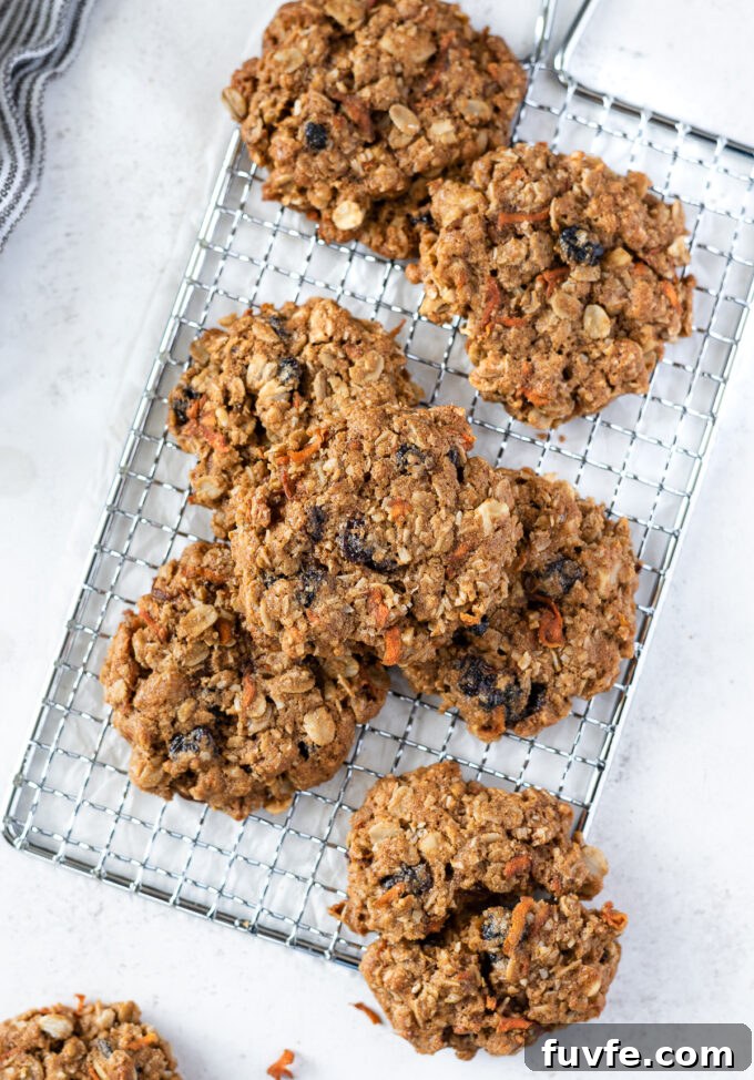 Chewy Carrot Oatmeal Cookies Recipe 3 Carrot and oatmeal cookies scattered on a wire rack.