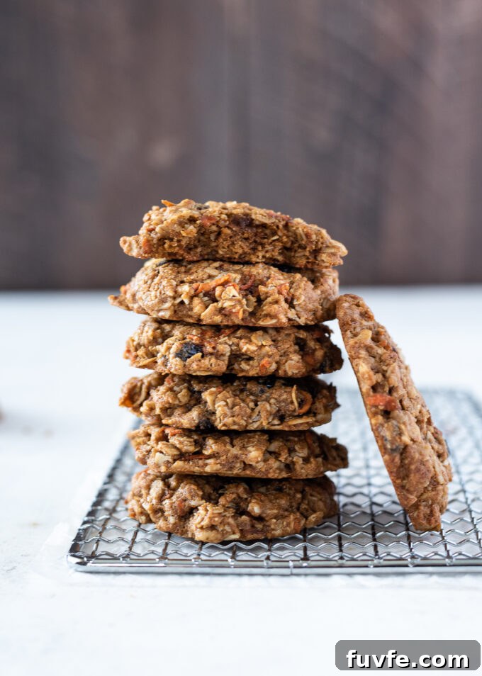Chewy Carrot Oatmeal Cookies Recipe 9 Carrot oatmeal cookies stacked with bite out of top cookie.