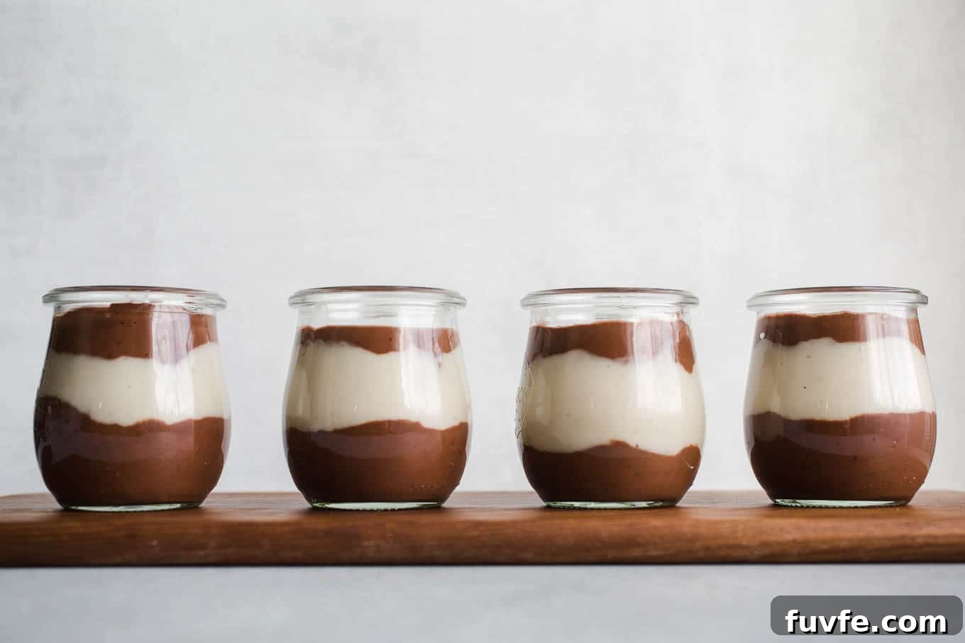 Vegan Chocolate Vanilla Pudding Cups made with rich chocolate cocoa powder, coconut milk, almond milk, maple syrup, and pure vanilla extract. An easy gluten-free, dairy-free pudding recipe!