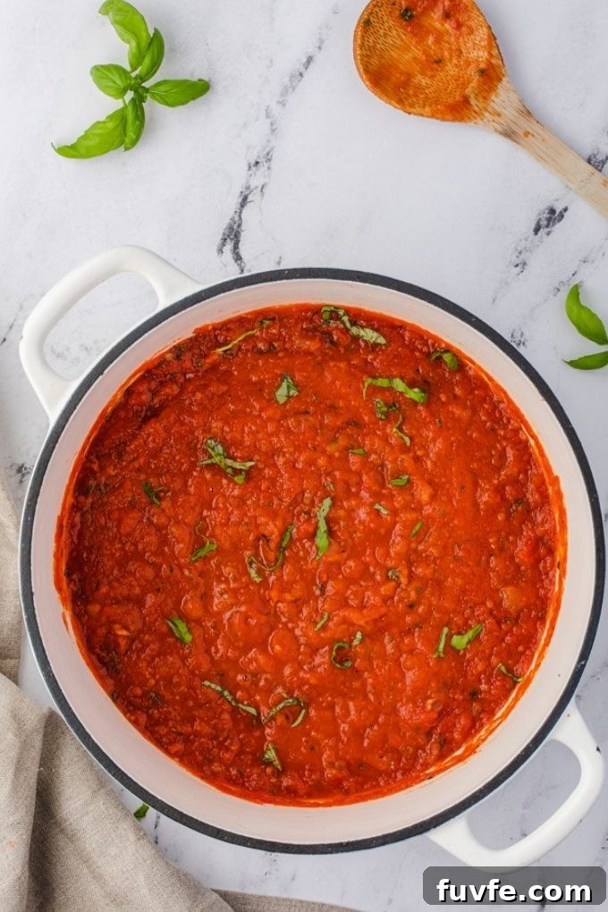Classic Homemade Marinara Sauce Recipe 3 Tomato basil sauce in Dutch oven with chopped basil on top
