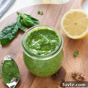 Spinach pesto in a jar with olive oil on top