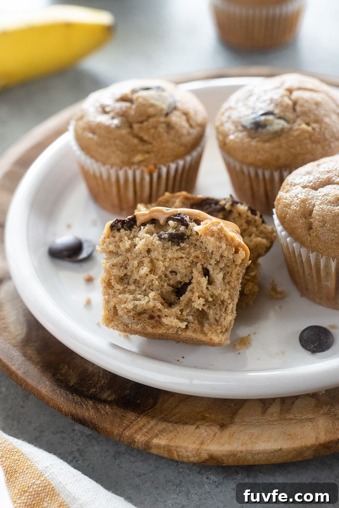Peanut butter banana muffins cut in half with chocolate chips exposed.