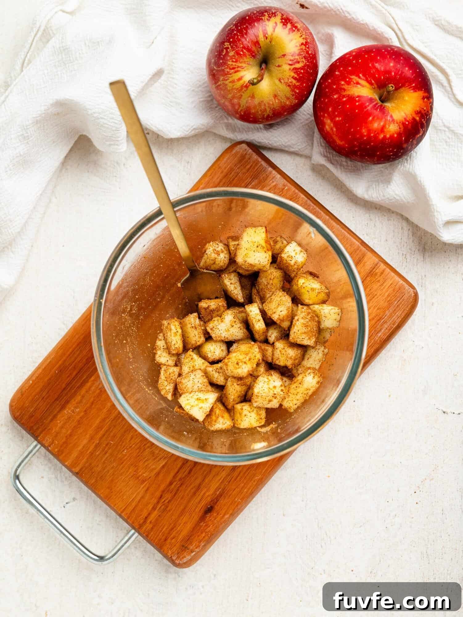 Chopped apple, coconut sugar and cinnamon in a small bowl.