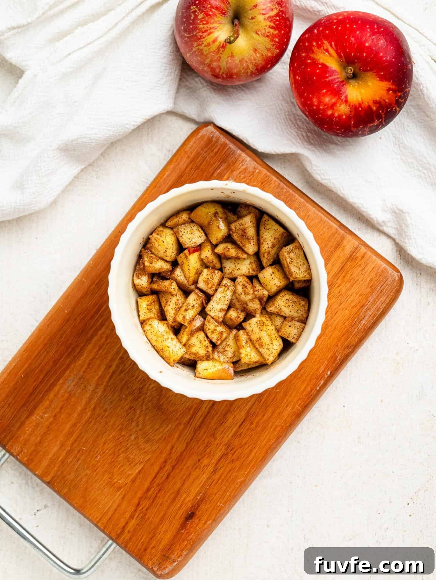 Chopped apple, coconut sugar and cinnamon in a small ramekin.