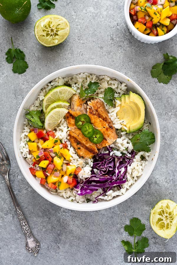 fish taco bowl in white bowl with salsa, cabbage and avocado