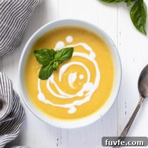 Summer squash soup with swirls of coconut milk and basil on top