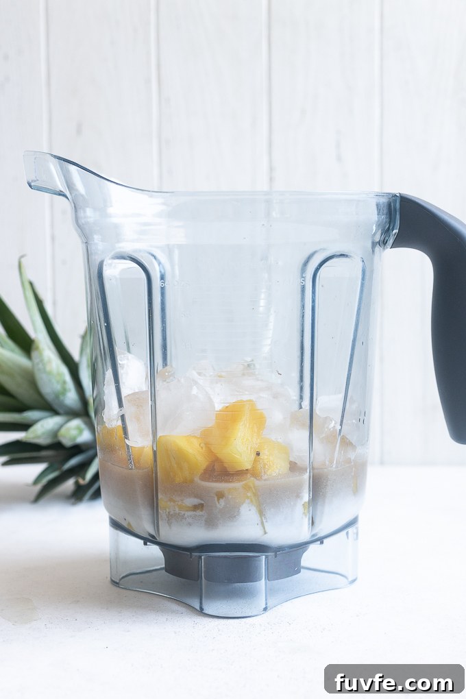 Pina colada recipe ingredients in a blender.