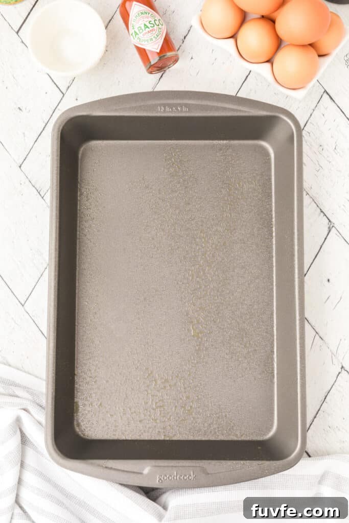 Greased 13x9-inch baking dish prepared for Chilies Rellenos Bake