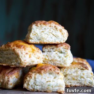 A stack of cheese biscuits on a wooden board.