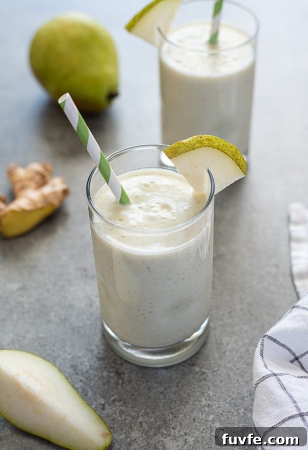 Silky Pear and Ginger Smoothie Recipe 3 front shot of pear smoothie with green striped straw and ginger