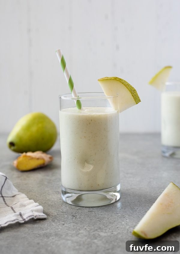 Silky Pear and Ginger Smoothie Recipe 4 close up of pear smoothie with pear and ginger in the background