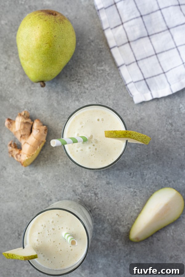 Silky Pear and Ginger Smoothie Recipe 5 overhead shot of pear smoothie recipe with straw and slice of pear