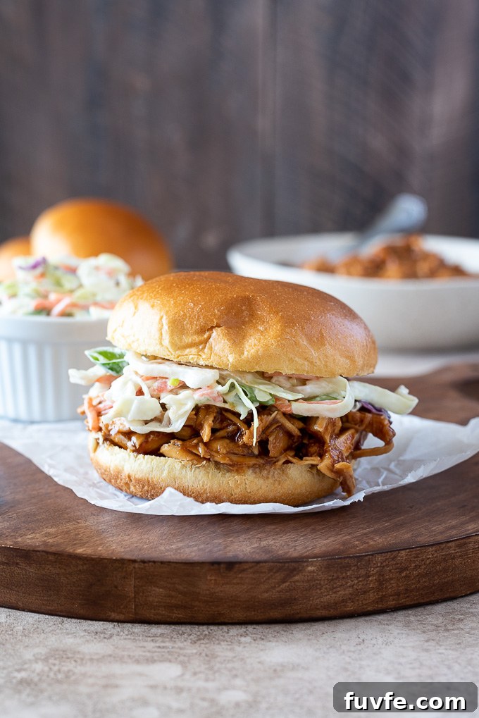Slow Cooker BBQ Pulled Chicken Sandwiches 5 BBQ pulled chicken sandwich topped with coleslaw