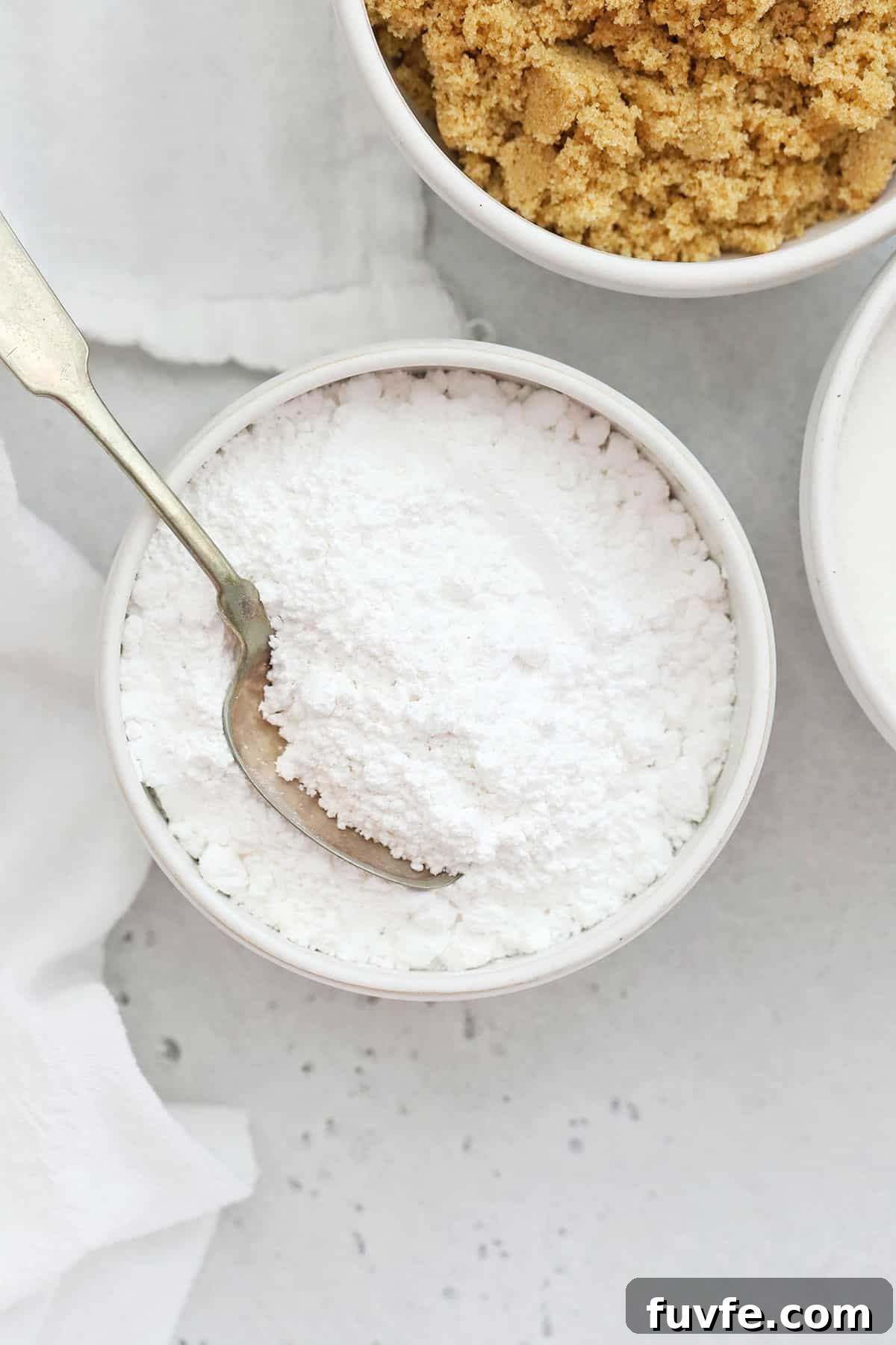 Is Sugar Gluten-Free? What You Need to Know About Sugars and Gluten 6 powdered sugar in a white bowl