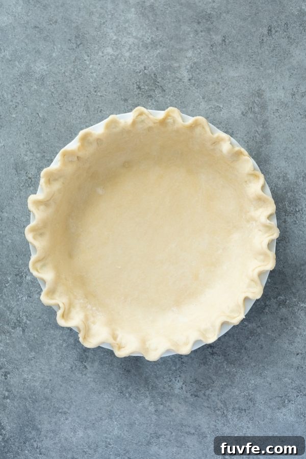 flaky pie crust crimped in pie plate