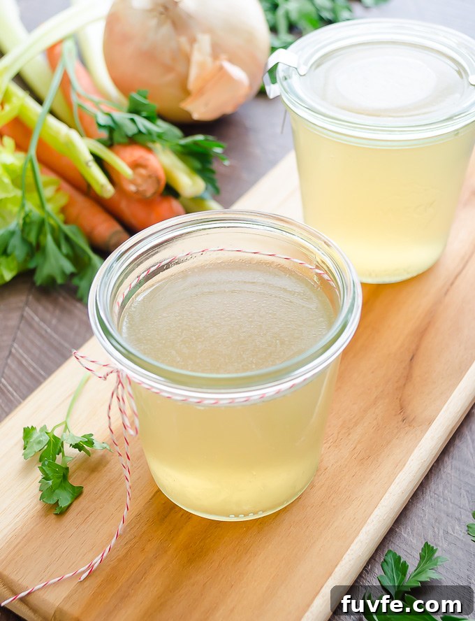 Jar of homemade turkey stock on a cutting board