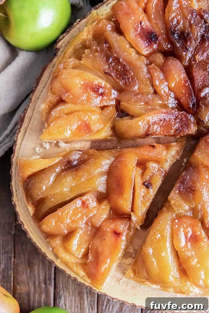 Apple tarte tatin sliced on a wooden serving board