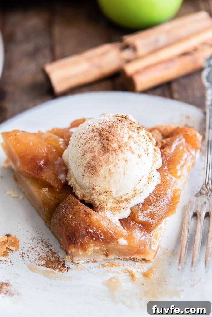 Slice of apple tarte tatin with a bite taken out of it
