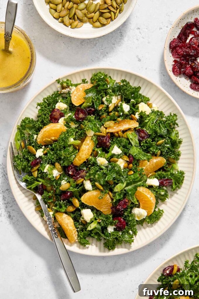 Kale and Orange Salad with Citrus Vinaigrette Recipe 6 Kale, orange, and goat cheese salad on a plate with a fork.