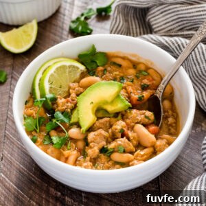 White Bean and Turkey Chili Recipe 5 Spoon in bowl of white bean turkey chili.