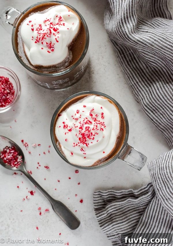 Slow Cooker Peppermint Hot Chocolate Recipe 4 Slow Cooker Peppermint Hot Chocolate in mugs with whipped cream and peppermint