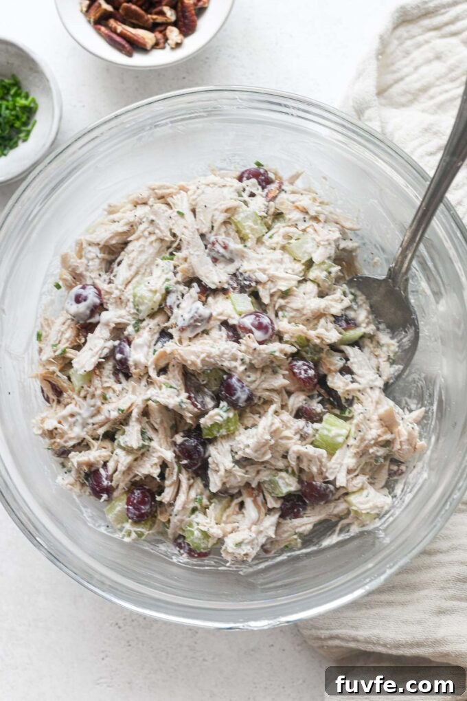 Chicken salad with grapes in a glass mixing bowl.