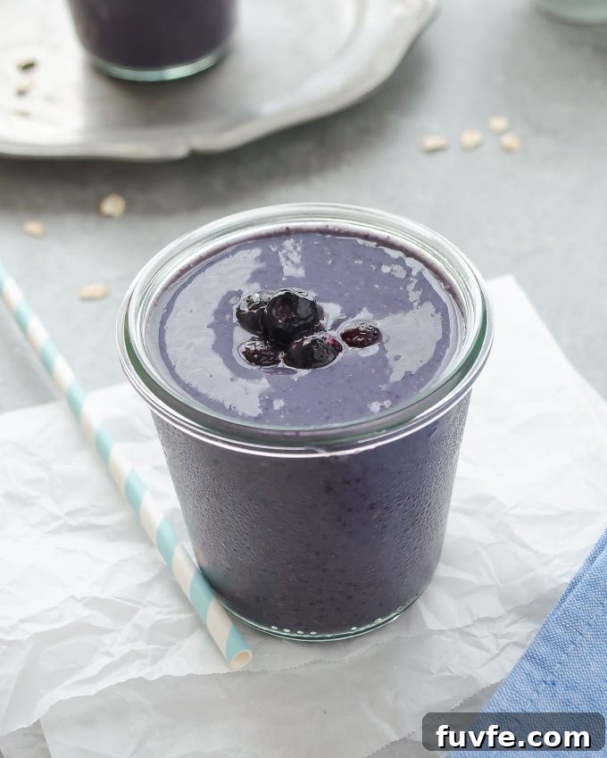 Creamy Blueberry Banana Smoothie Recipe 2 Blueberry banana oat smoothie with berries on top