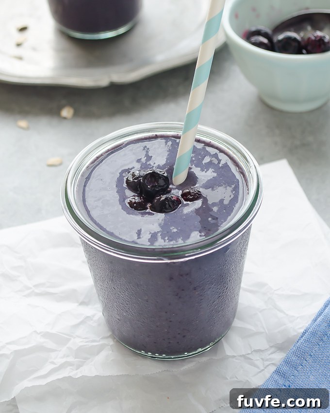 Creamy Blueberry Banana Smoothie Recipe 7 Blueberry and banana smoothie in a jar with a straw