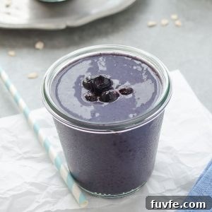 Blueberry banana oat smoothie with berries on top