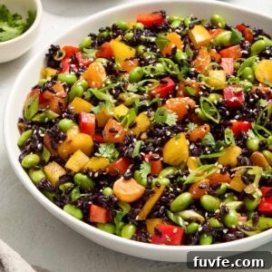 Asian rice salad in a white serving bowl.