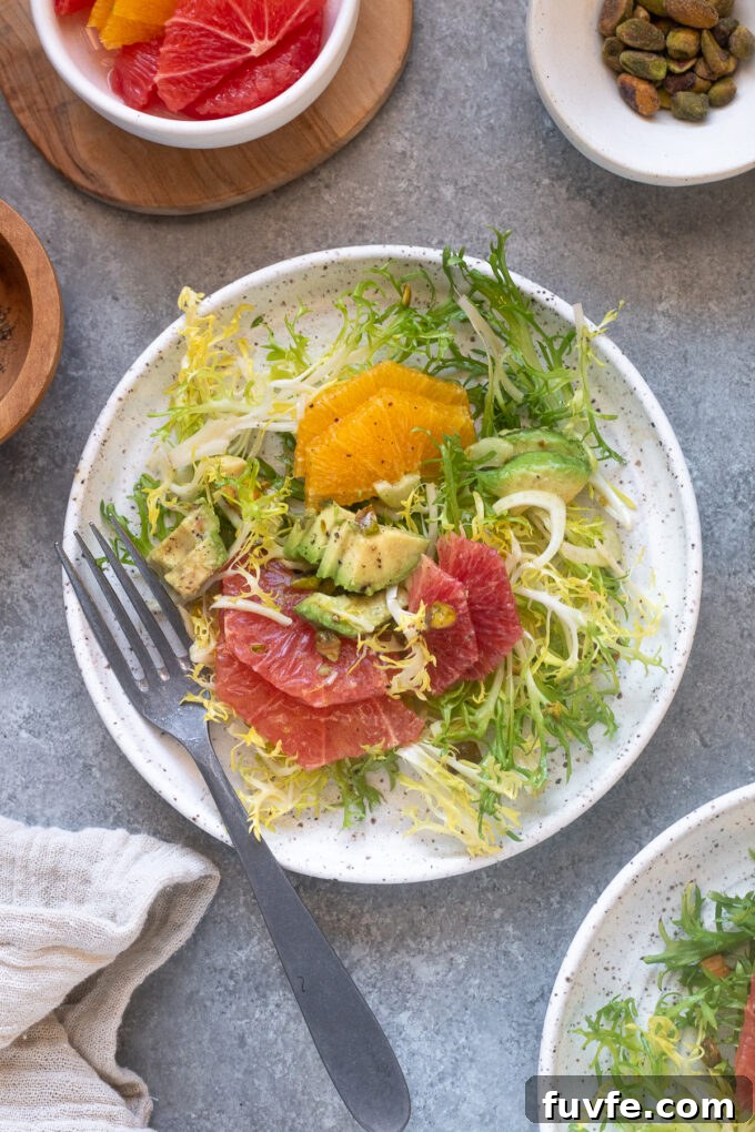 Citrus fennel salad on a plate with a fork.