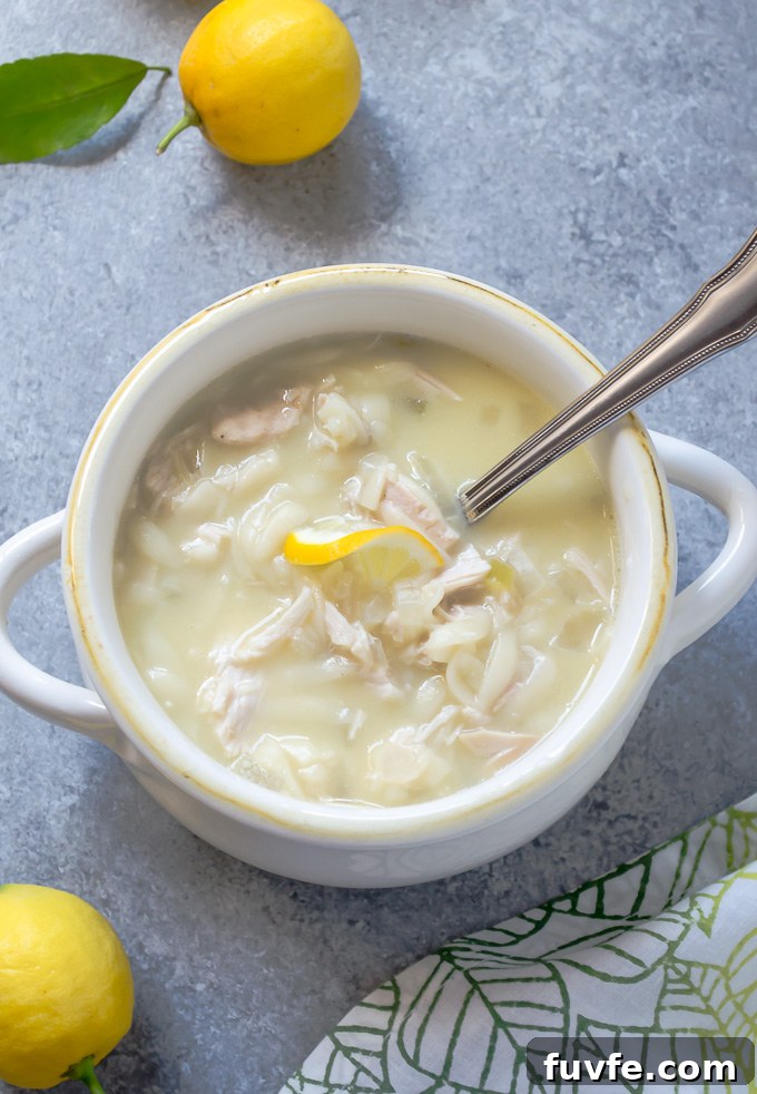 Slow cooker Greek avgolemono soup in a bowl with spoon buried inside
