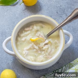 Slow cooker Greek lemon chicken soup in a white bowl